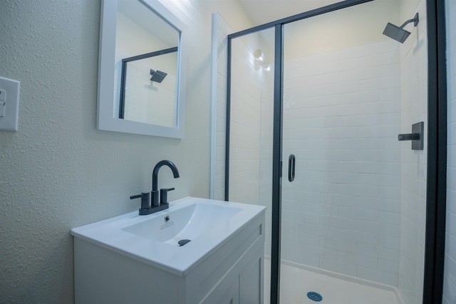 bathroom with vanity and an enclosed shower