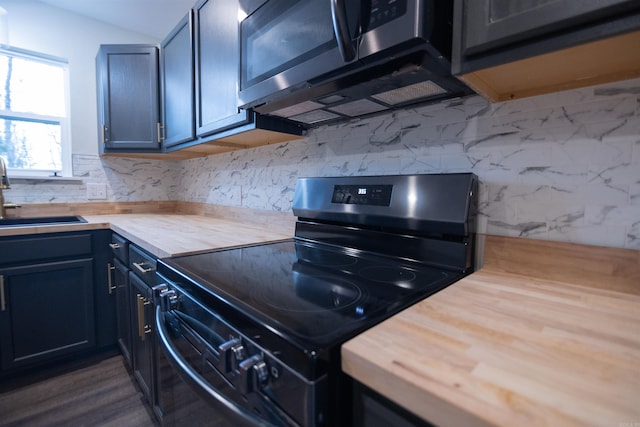 kitchen with sink, tasteful backsplash, wooden counters, dark hardwood / wood-style floors, and range with electric cooktop