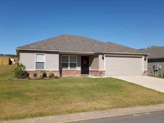 single story home with a garage and a front yard