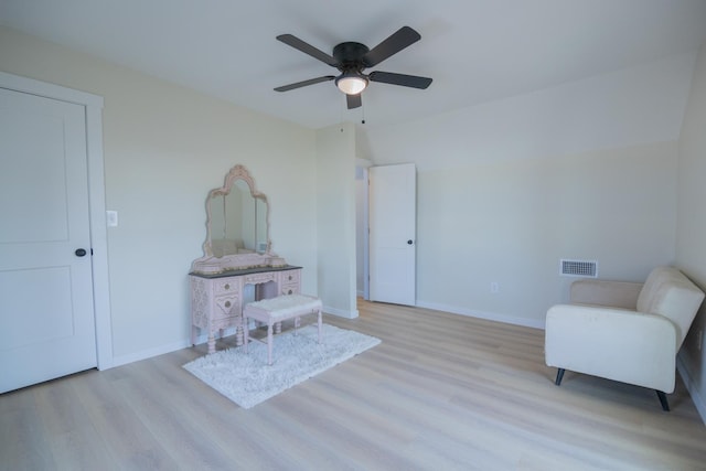 living area with ceiling fan and light wood-type flooring