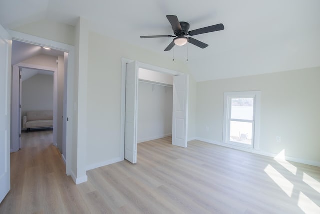 unfurnished bedroom with vaulted ceiling, ceiling fan, light hardwood / wood-style floors, and a closet