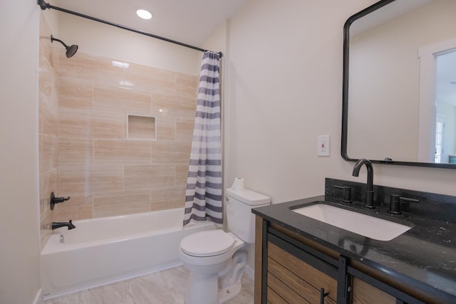 full bathroom with vanity, shower / tub combo, and toilet