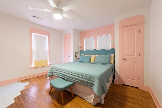 bedroom with ceiling fan and hardwood / wood-style floors