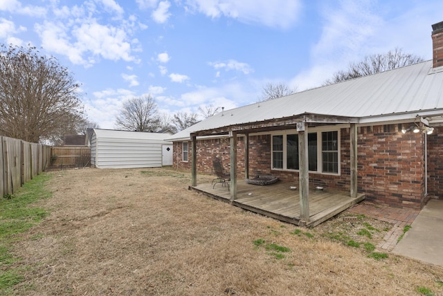 view of yard featuring a wooden deck and a storage unit