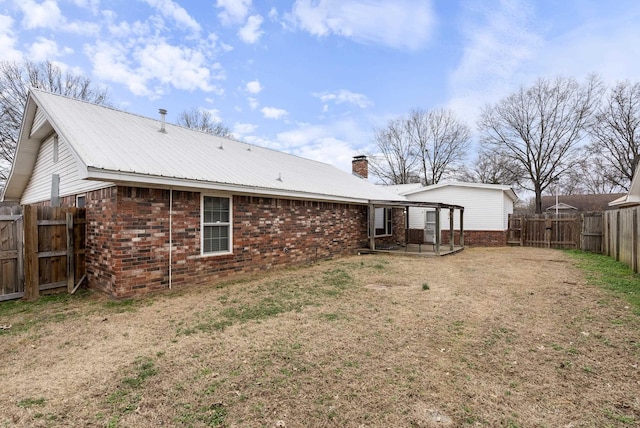 rear view of house featuring a lawn