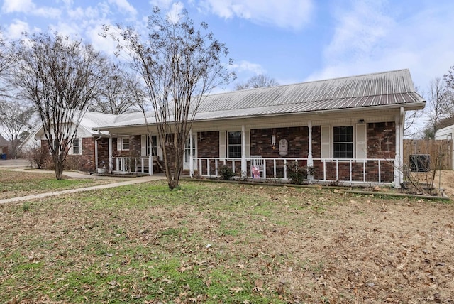 single story home with a front yard and a porch