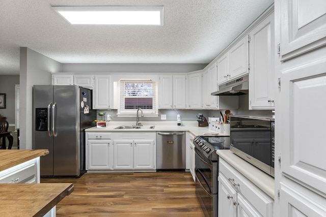 kitchen featuring stainless steel appliances, white cabinetry, sink, and dark hardwood / wood-style floors