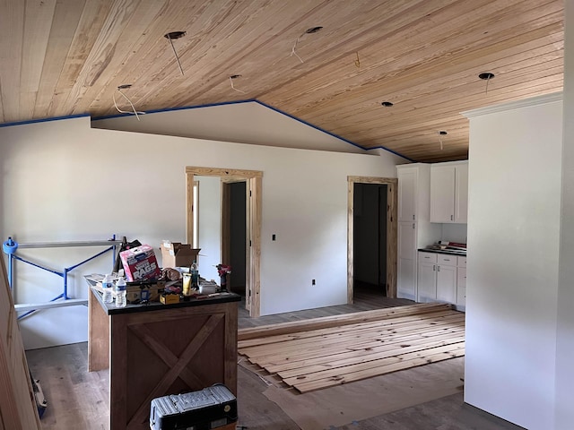 605 Frances Cv, Mountain View, AR 72560 - kitchen with vaulted ceiling, white cabinets, wood ceiling, dark countertops, and wood finished floors