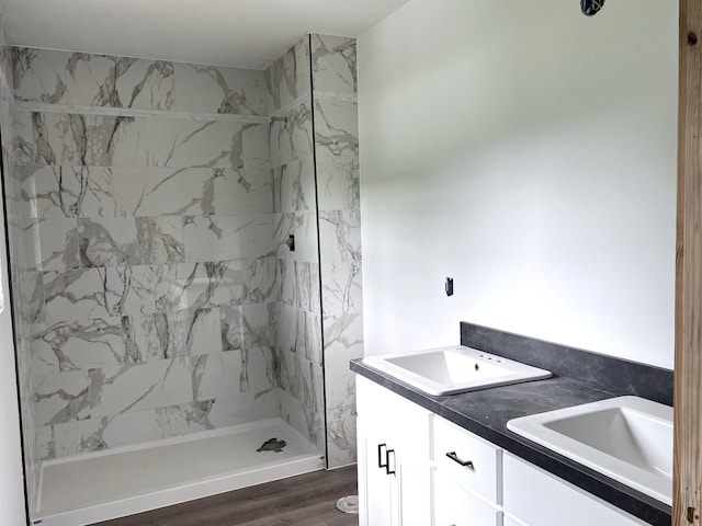 605 Frances Cv, Mountain View, AR 72560 - bathroom featuring a stall shower, double vanity, and wood finished floors