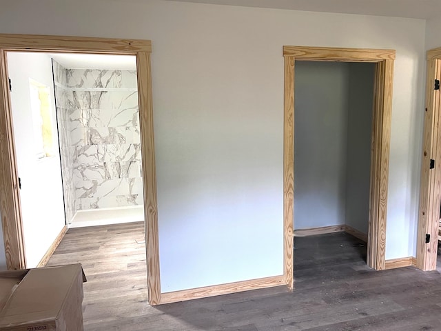 605 Frances Cv, Mountain View, AR 72560 - unfurnished bedroom with baseboards, wood finished floors, and ensuite bath