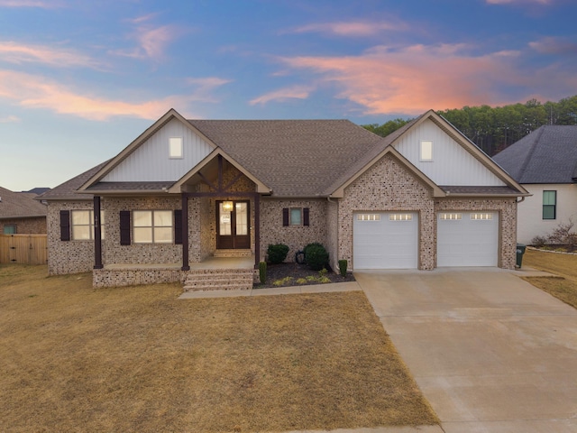 craftsman inspired home with a garage and a lawn