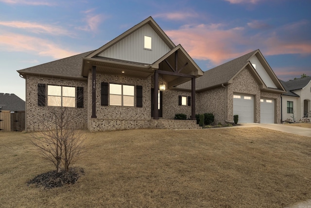 view of front facade with a garage and a yard