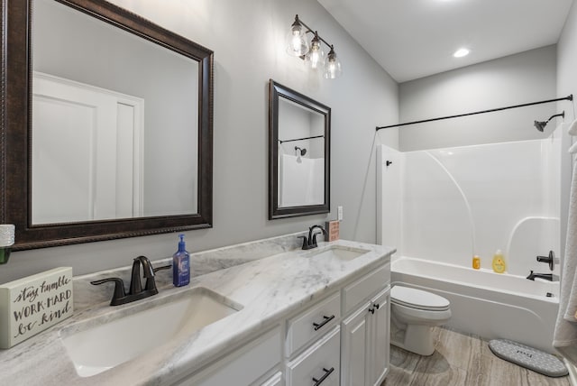 full bathroom featuring shower / bath combination, vanity, hardwood / wood-style floors, and toilet