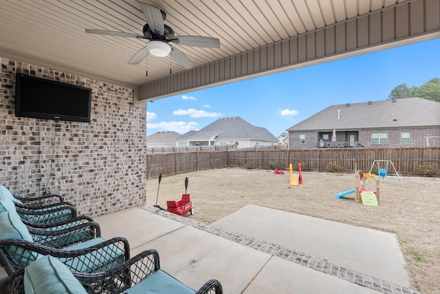 view of patio with a playground and ceiling fan