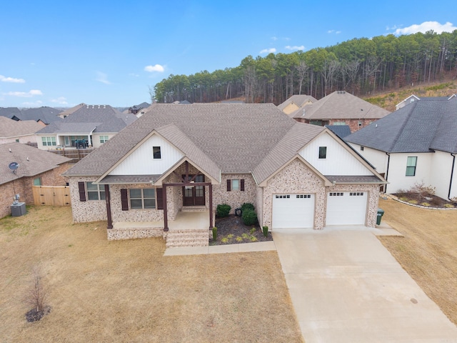 view of front of home with a garage, a porch, and a front yard