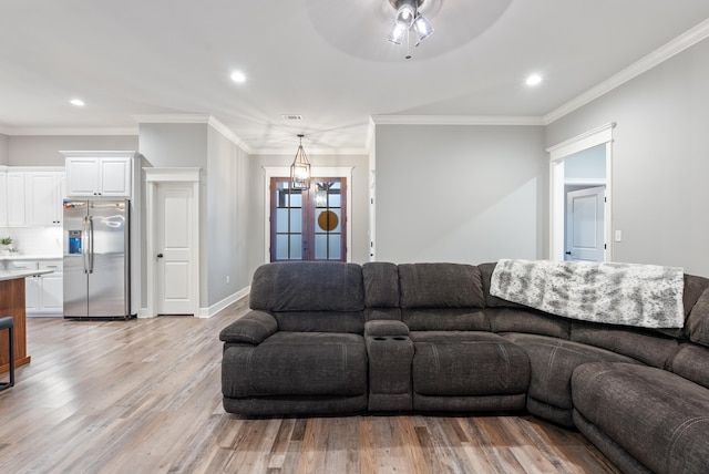 living room featuring ornamental molding, ceiling fan, and light hardwood / wood-style floors