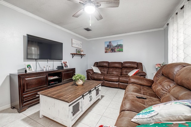 living room with ceiling fan, ornamental molding, a textured ceiling, and light tile patterned floors