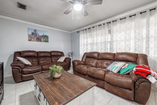 tiled living room featuring crown molding, ceiling fan, and a textured ceiling