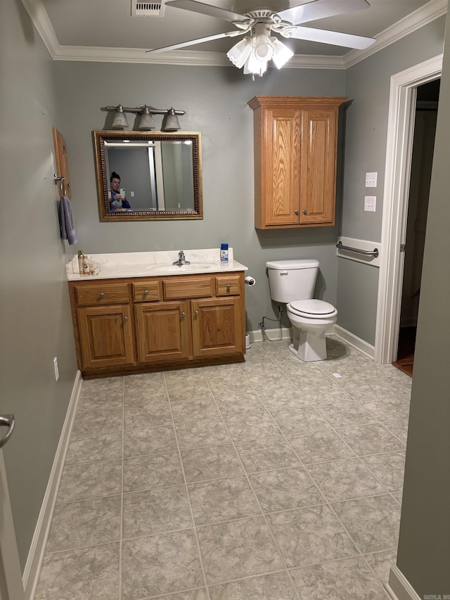 bathroom featuring ornamental molding, vanity, ceiling fan, toilet, and tile patterned floors