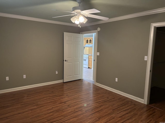 empty room with dark wood-type flooring, ceiling fan, and ornamental molding