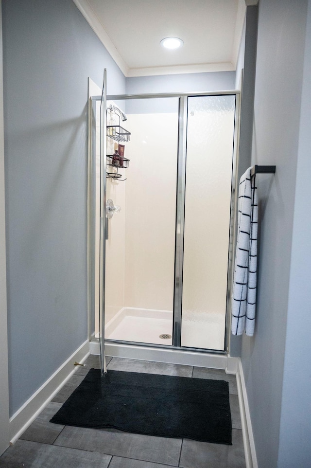 bathroom featuring ornamental molding, hardwood / wood-style floors, and a shower