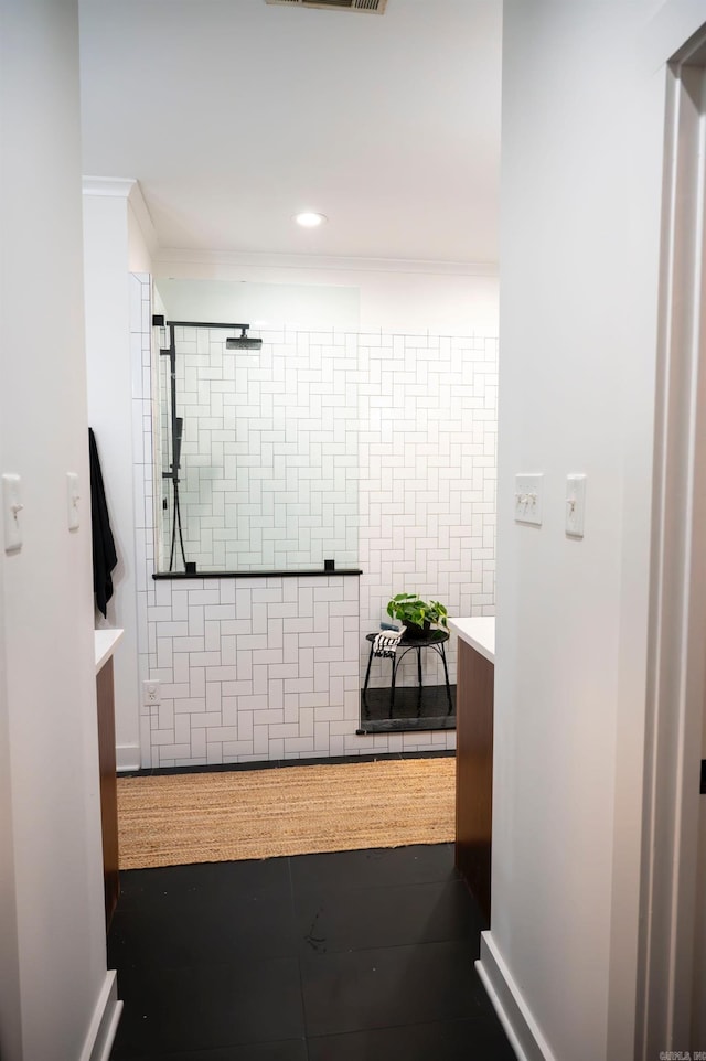 bathroom with a shower, ornamental molding, and vanity