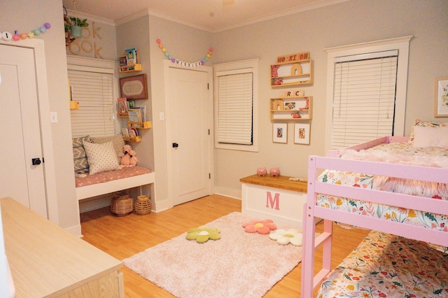 bedroom with crown molding and wood-type flooring