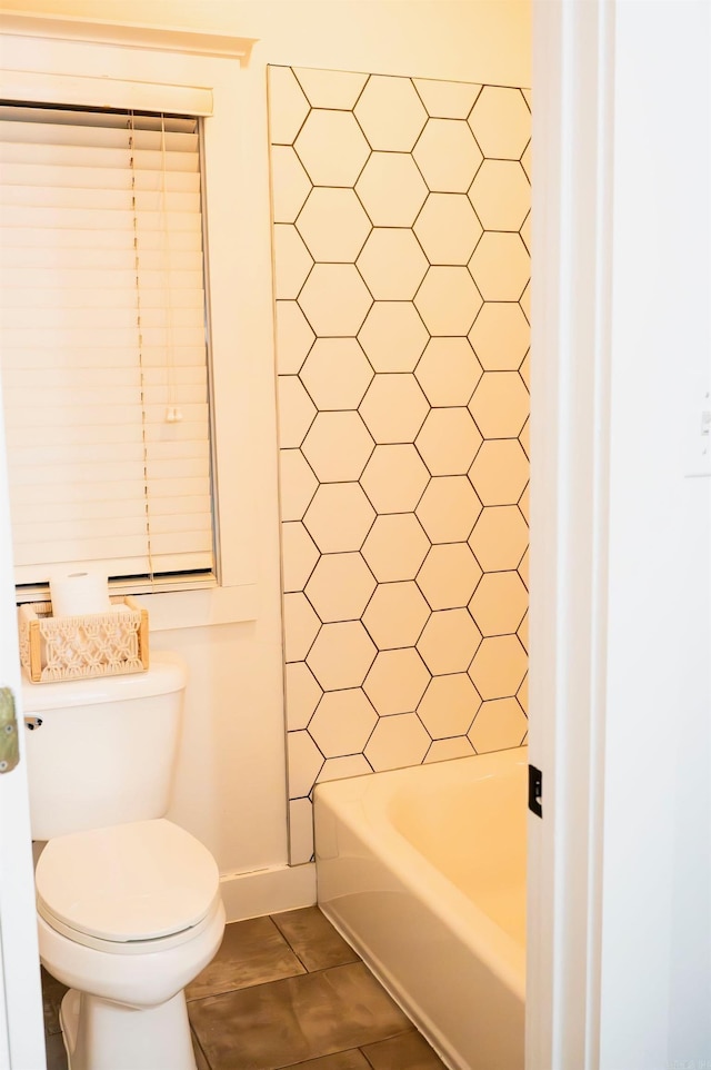 bathroom with shower with separate bathtub, tile patterned floors, and toilet