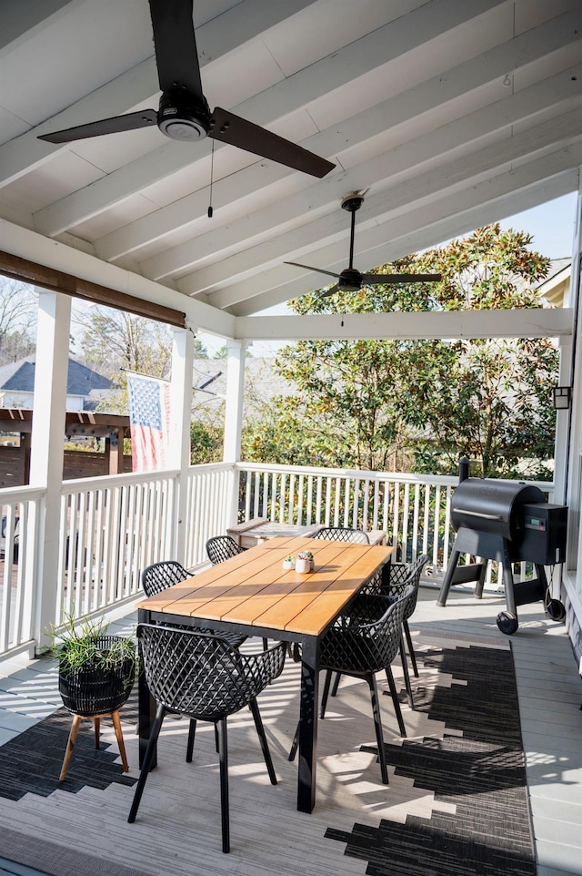 wooden terrace featuring grilling area and ceiling fan