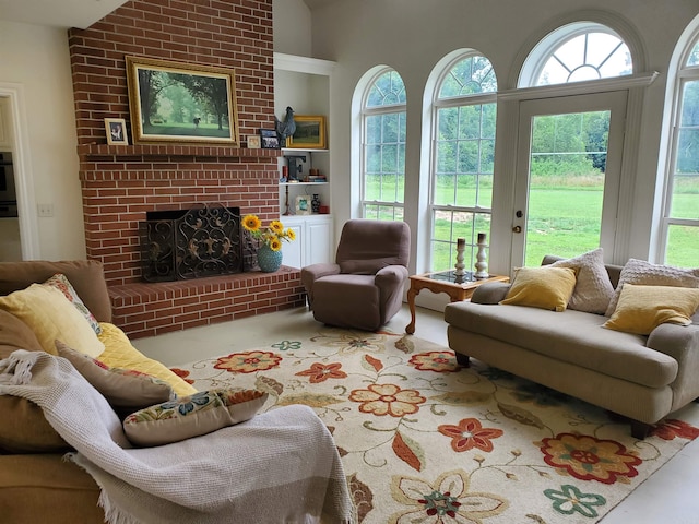 living room featuring lofted ceiling, a brick fireplace, and carpet