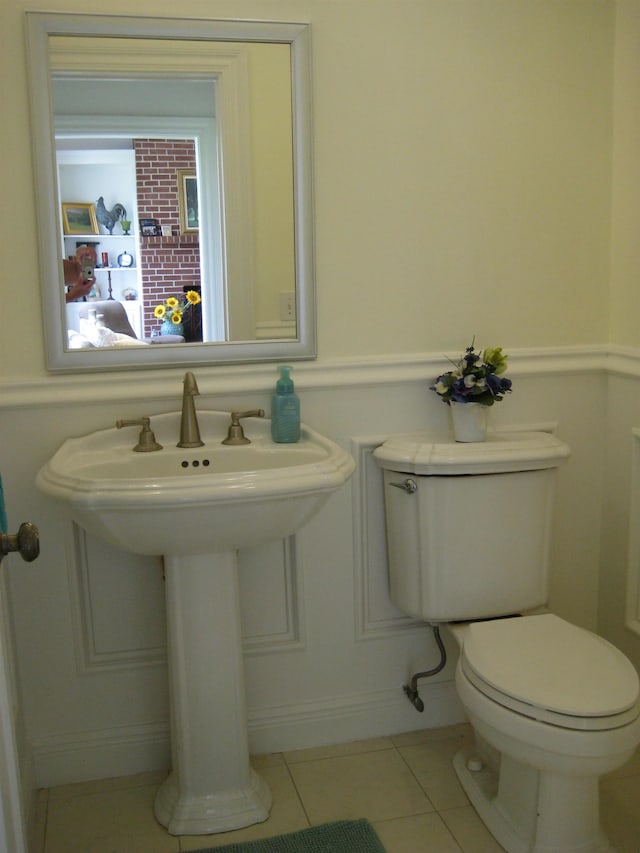 bathroom featuring tile patterned floors, toilet, and sink