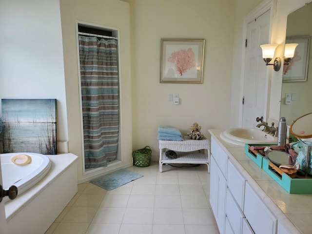 bathroom featuring vanity, tile patterned flooring, and separate shower and tub