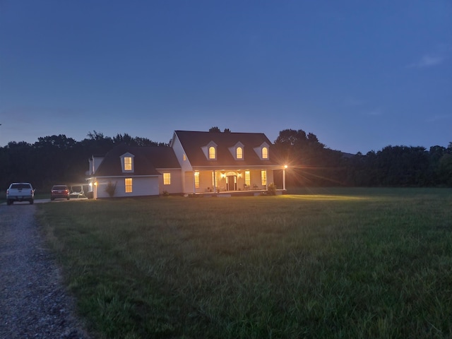 cape cod-style house featuring a lawn