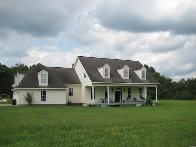 new england style home with a porch and a front yard