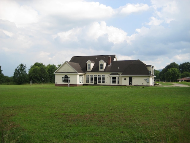 cape cod home with a front lawn