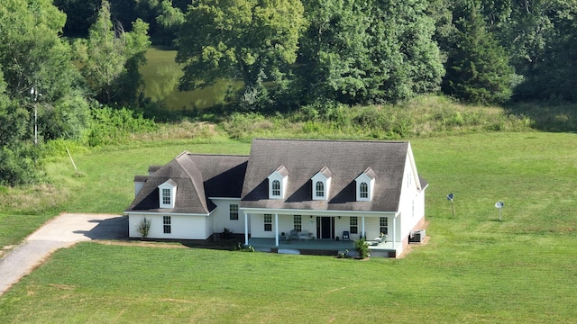 view of front of property featuring covered porch and a front lawn