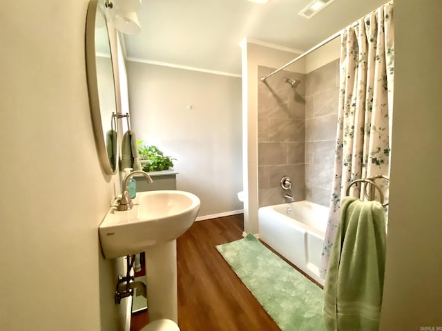 bathroom with shower / tub combo, crown molding, wood-type flooring, and toilet