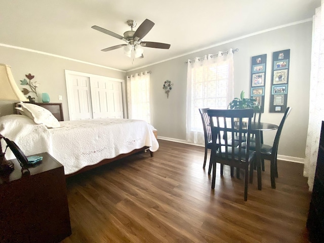 bedroom with crown molding, dark wood-type flooring, a closet, and ceiling fan