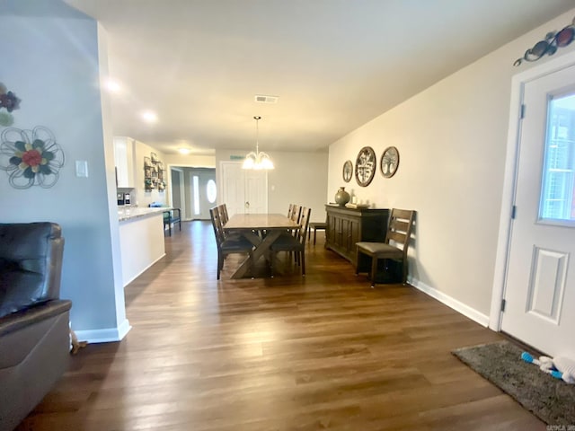 dining room featuring dark wood-type flooring and a chandelier