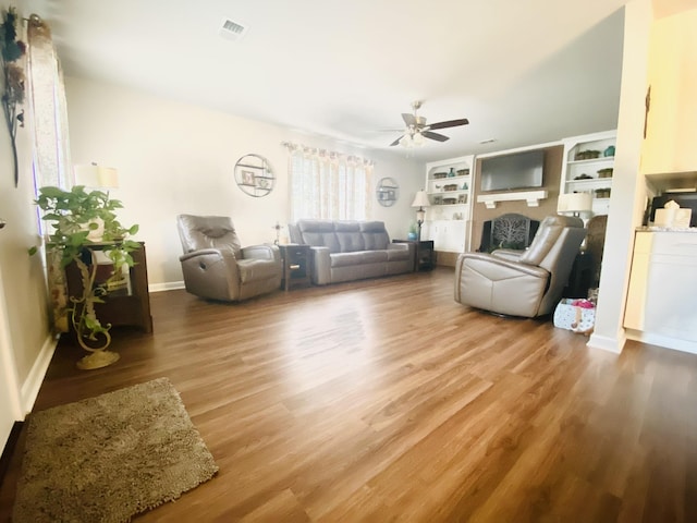 unfurnished living room with wood-type flooring and ceiling fan