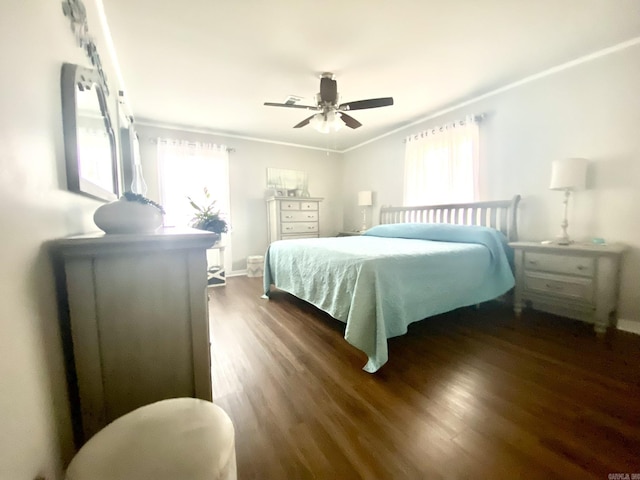 bedroom featuring ornamental molding, dark hardwood / wood-style floors, and ceiling fan