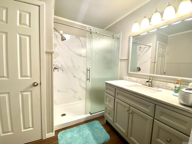 bathroom featuring crown molding, hardwood / wood-style floors, vanity, and walk in shower