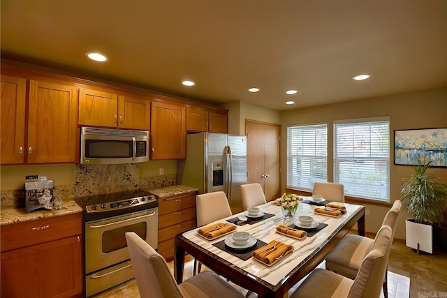 kitchen featuring backsplash and stainless steel appliances