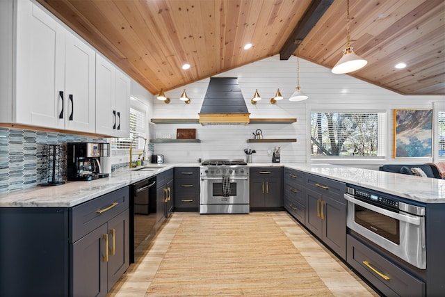 kitchen with high end range, hanging light fixtures, white cabinetry, and premium range hood