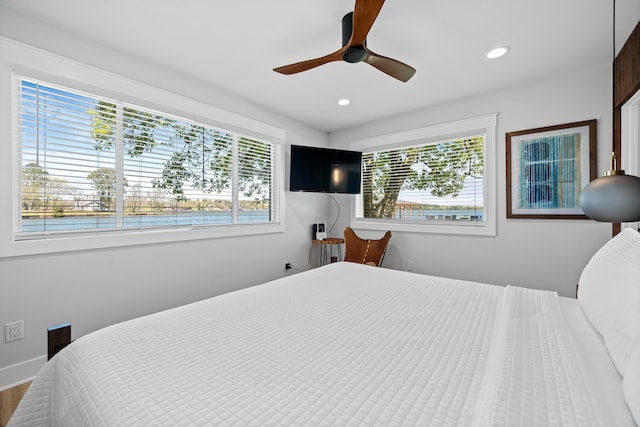 bedroom featuring multiple windows and ceiling fan