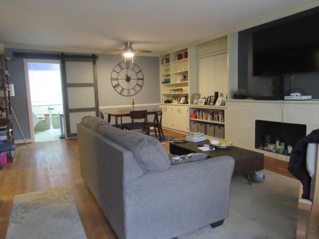 living room with hardwood / wood-style floors and ceiling fan