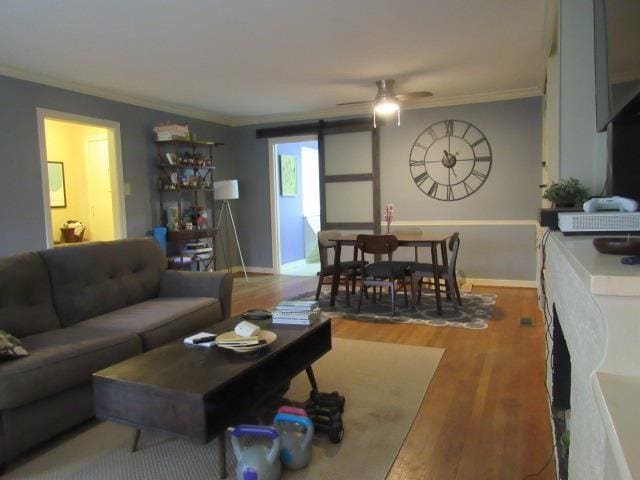 living room with crown molding and wood-type flooring