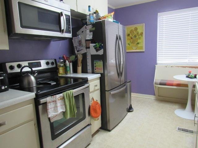 kitchen featuring appliances with stainless steel finishes and white cabinets