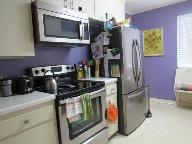 kitchen featuring stainless steel appliances and white cabinets