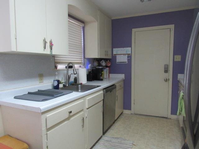 kitchen featuring sink, stainless steel dishwasher, and white cabinets